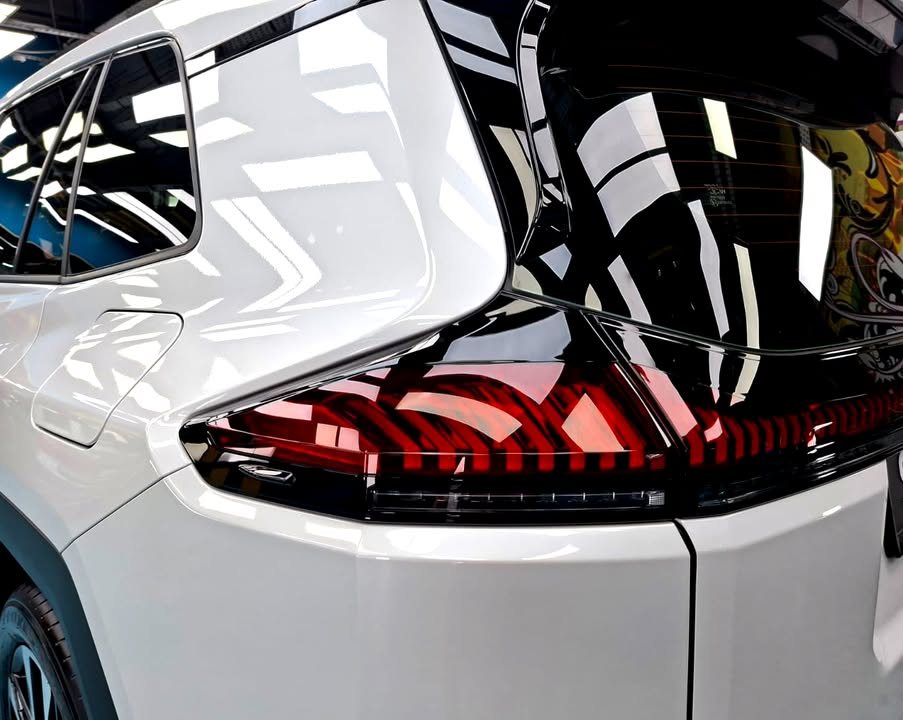 Close-up of the RAV4 tail light on the white rear quarter.