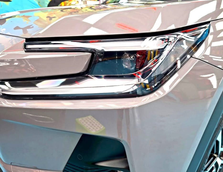 Close-up of the RAV4 headlamp and grey front wing.