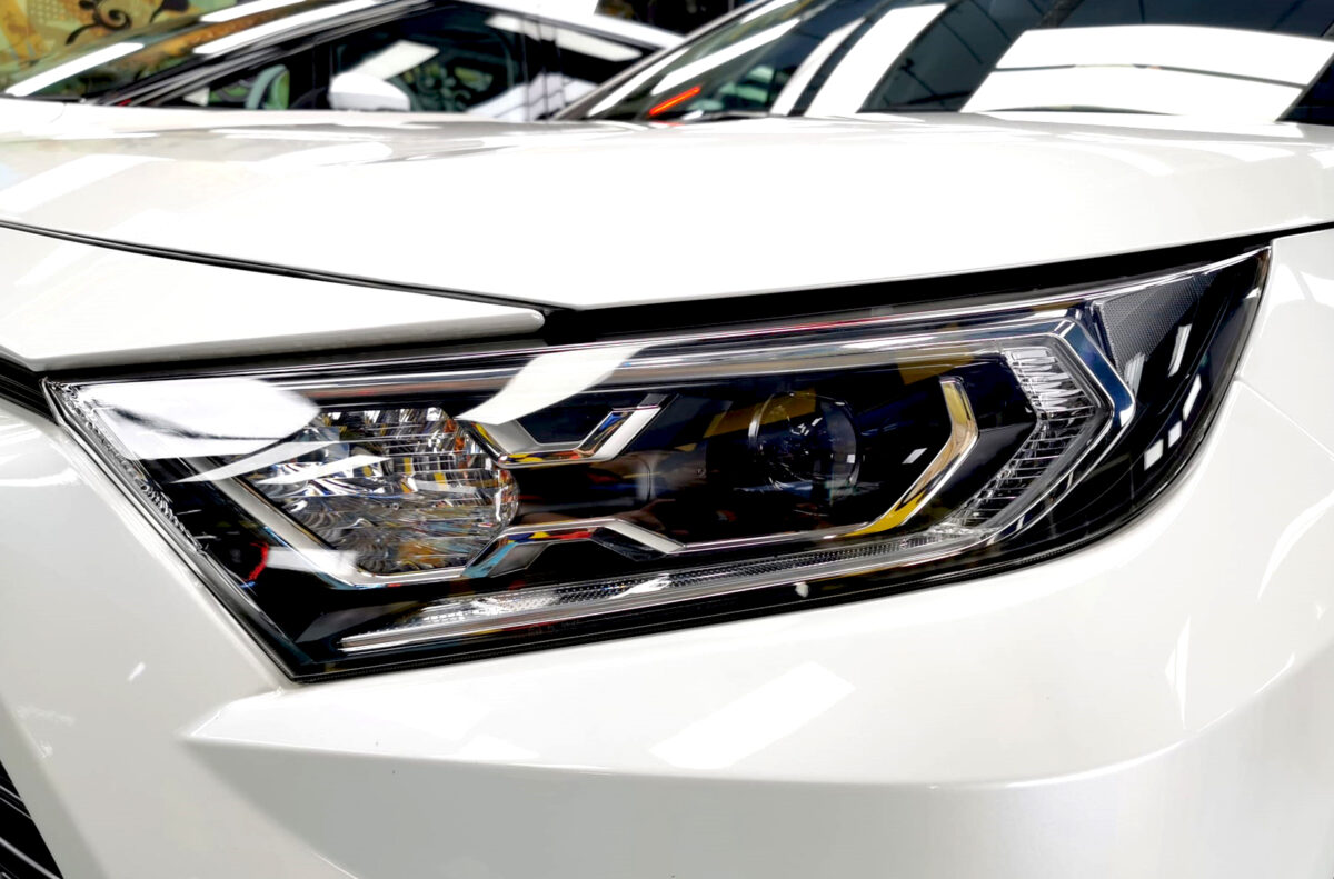 The RAV4's coated paintwork showing clean reflections.