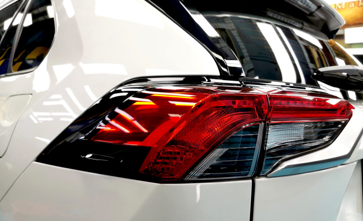 The coated bonnet of the Toyota RAV4 under workshop lighting.