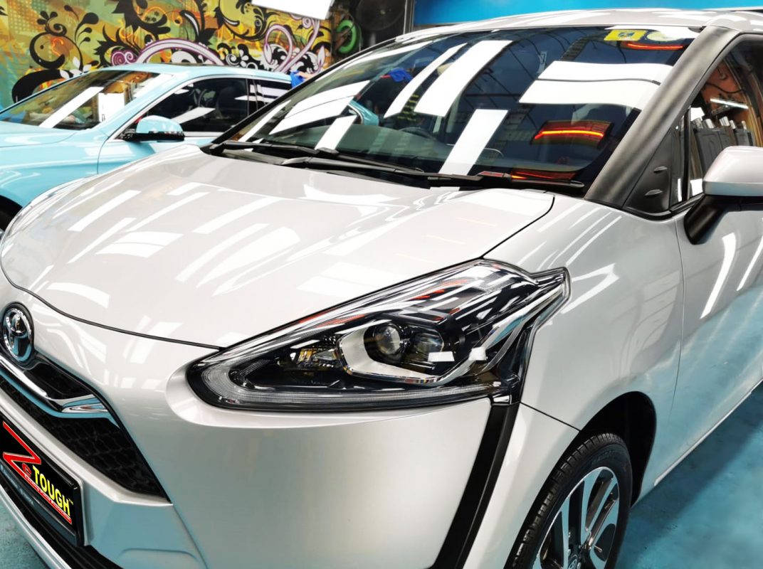 The Toyota Sienta from a side angle after the ceramic coating.