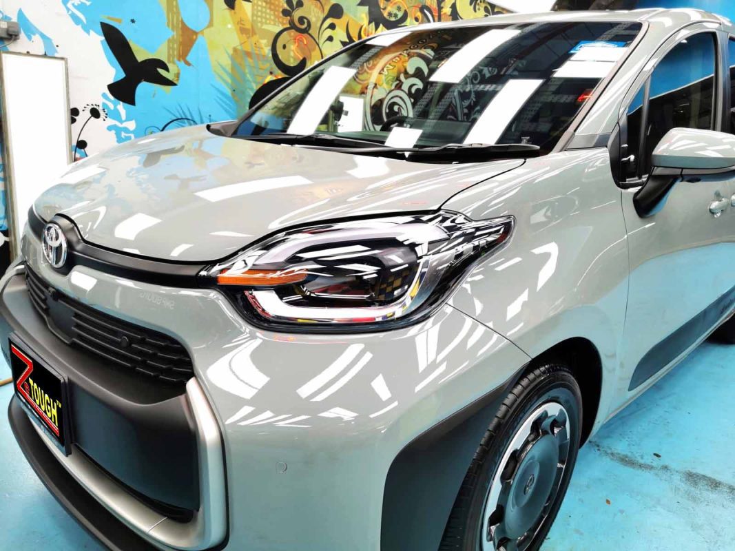 The Toyota Sienta Hybrid from a side angle after the ceramic coating.