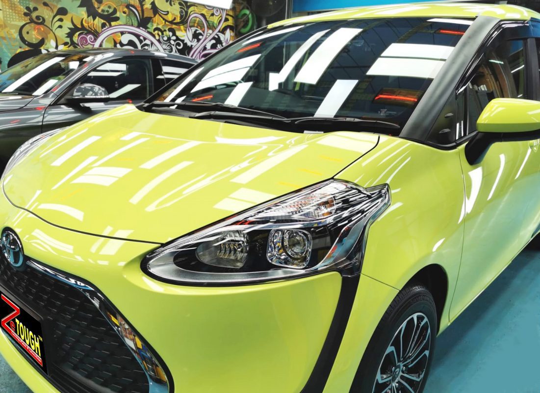 The Toyota Sienta from a side angle after the ceramic coating.