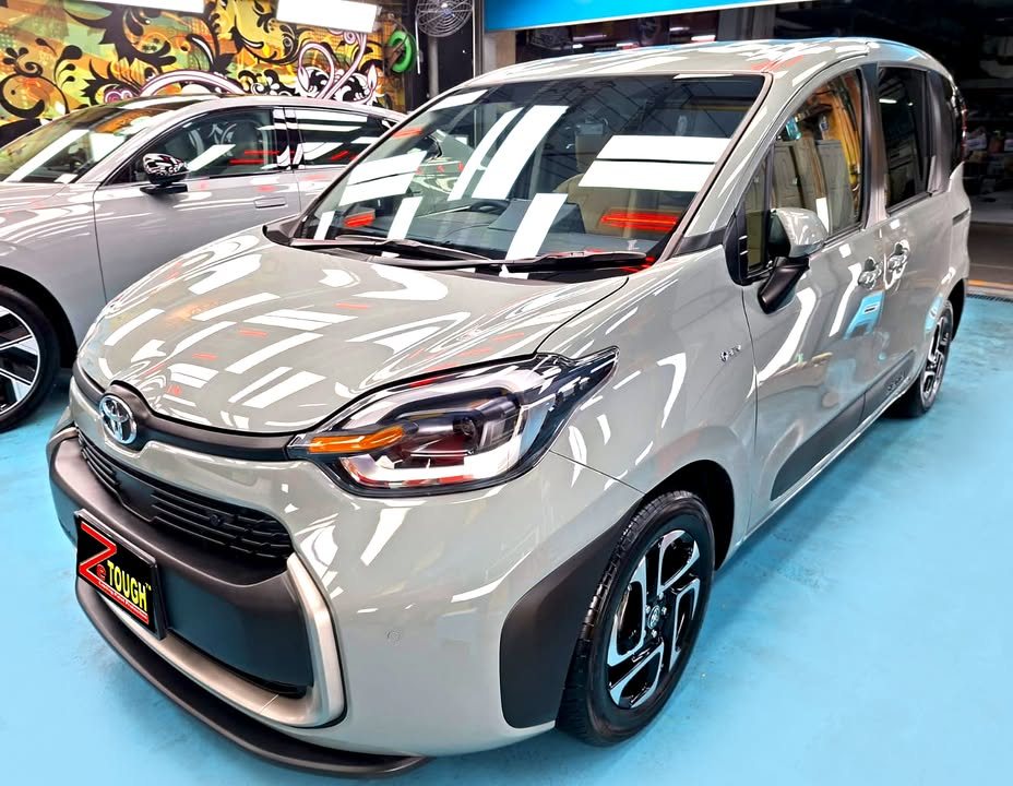 Grey Toyota Sienta front three-quarter view in the Revol Carz workshop after ZeTough Titanium coating.