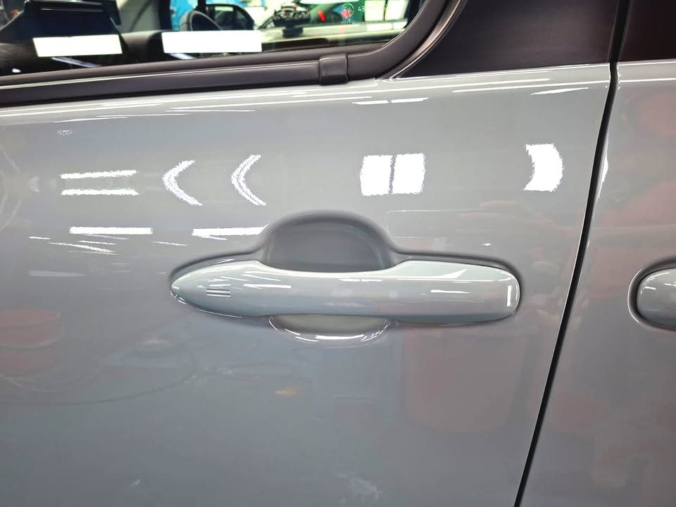 Door handle on the grey Sienta door panel.