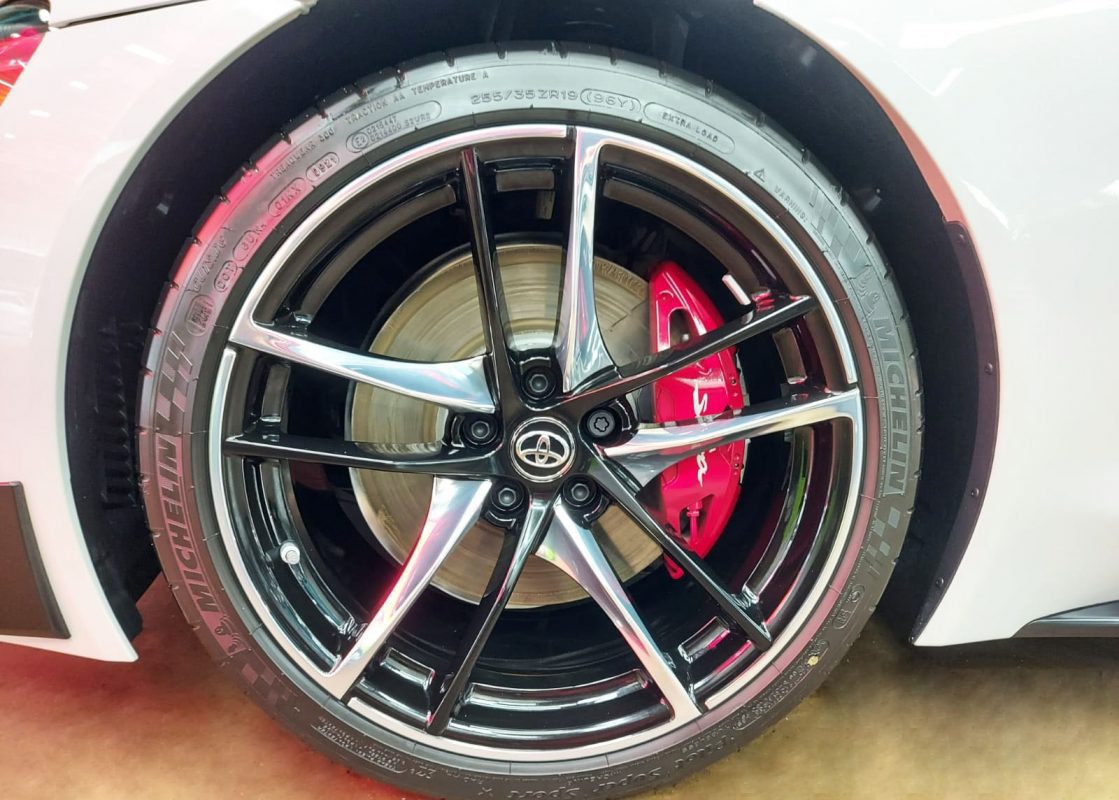 The coated bodywork of the Toyota Supra RZ under workshop lighting.