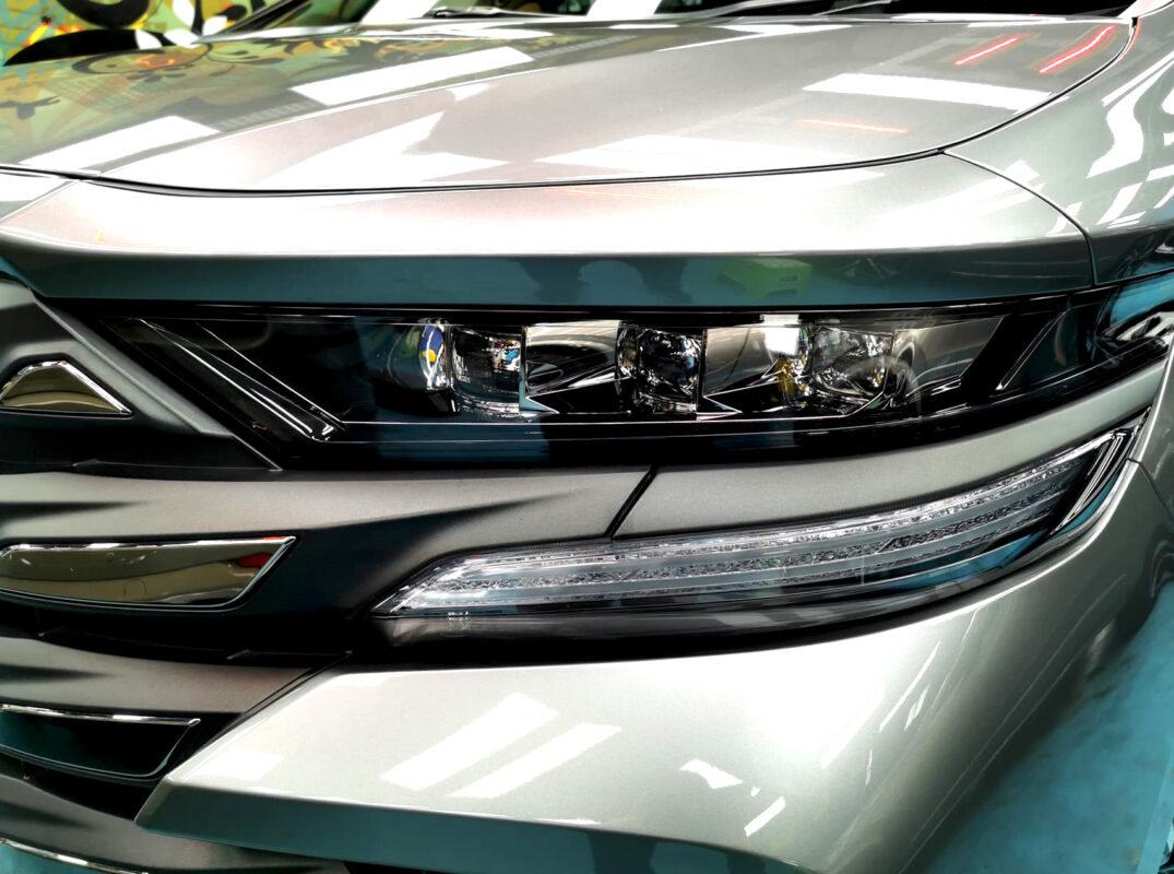 The Vellfire's coated paintwork showing clean reflections.