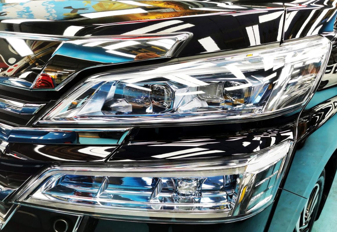 The Vellfire's coated paintwork showing clean reflections.