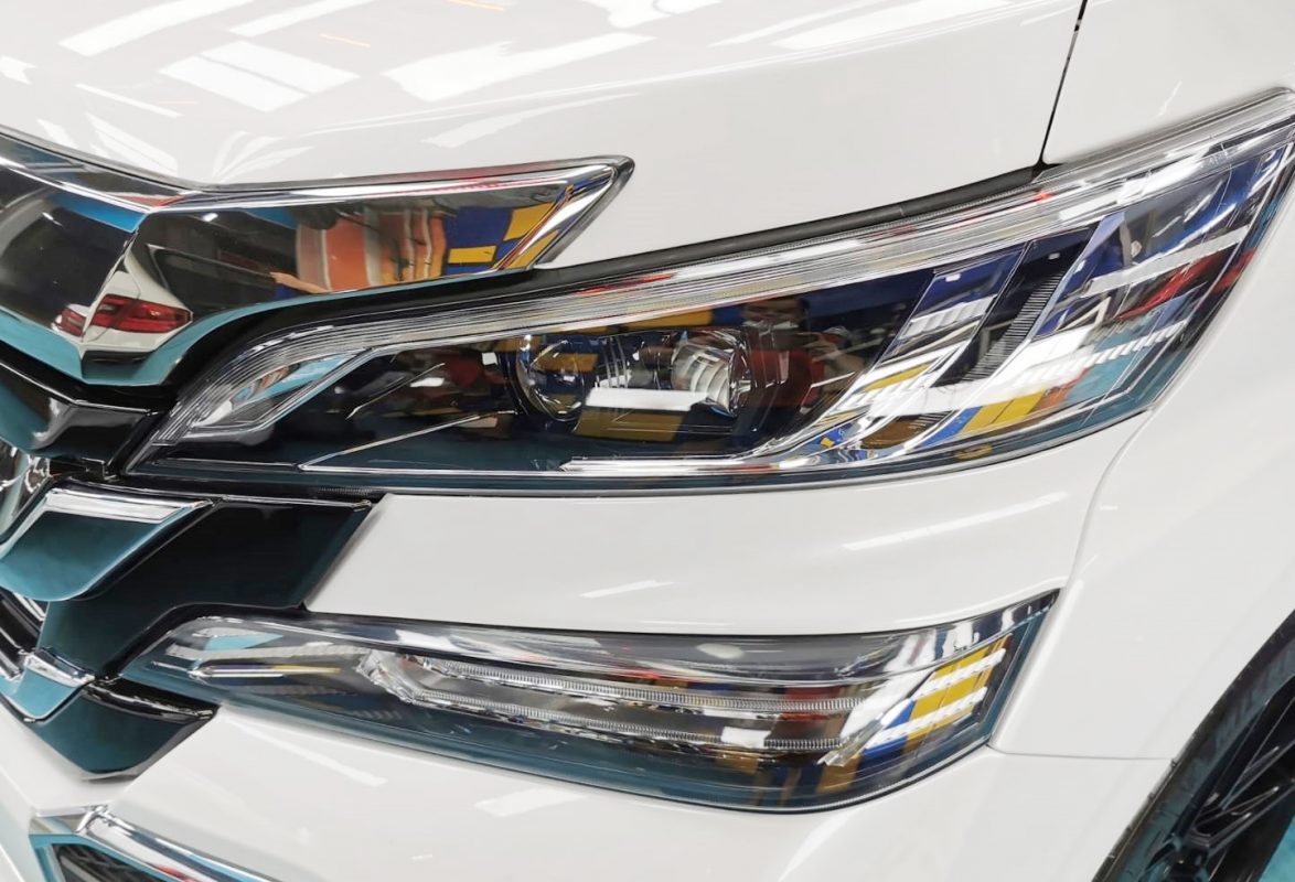 The Vellfire's coated paintwork showing clean reflections.