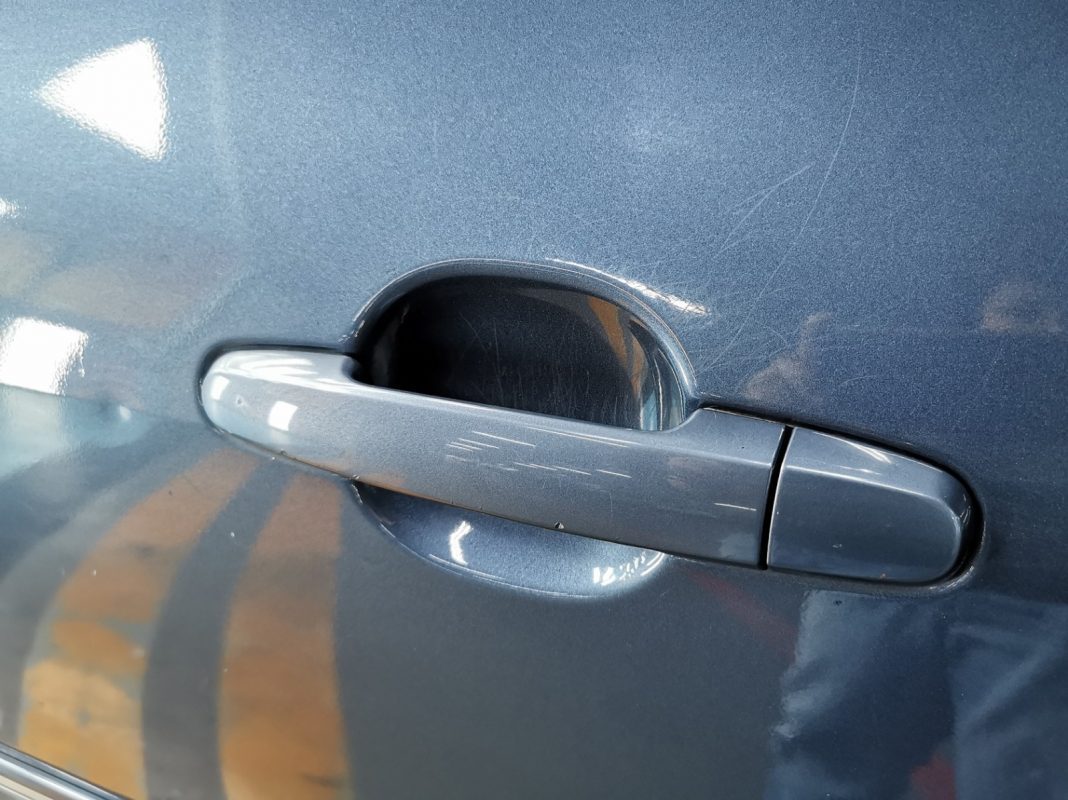 Deep scratches and stone chips on the Toyota Vios at intake.