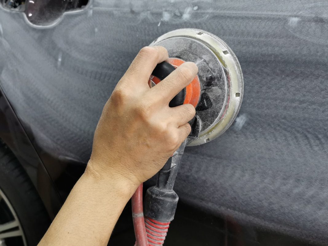 Repairing scratches and applying putty to the Vios's body.