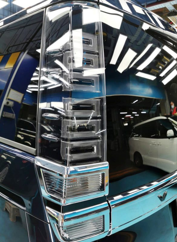 The coated bonnet of the Toyota Voxy under workshop lighting.