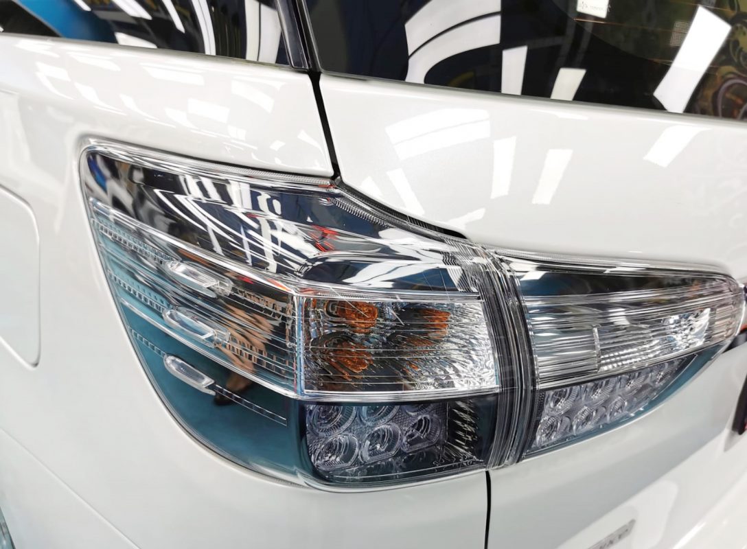The coated bonnet of the Toyota Wish under workshop lighting.