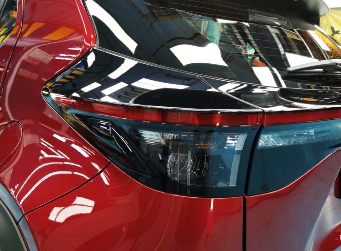 The coated bonnet of the Toyota Yaris under workshop lighting.