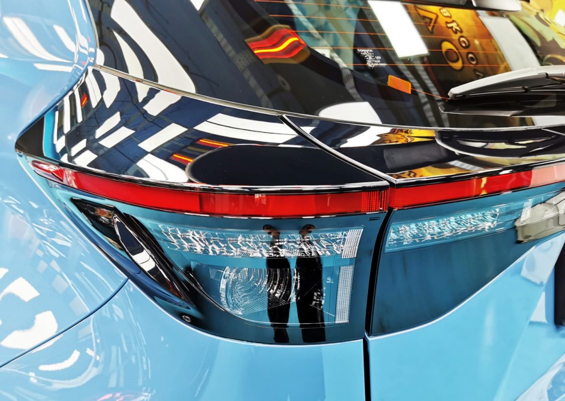 The coated bonnet of the Toyota Yaris Cross under workshop lighting.
