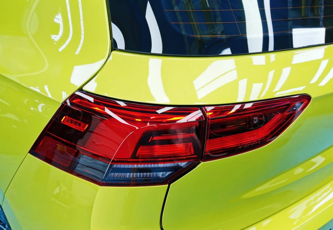 The coated bonnet of the Golf under workshop lighting.