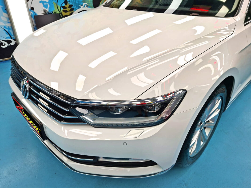 The Volkswagen Passat's coated paintwork under workshop lighting.