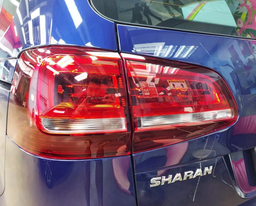 The coated bonnet of the Volkswagen Sharan under workshop lighting.