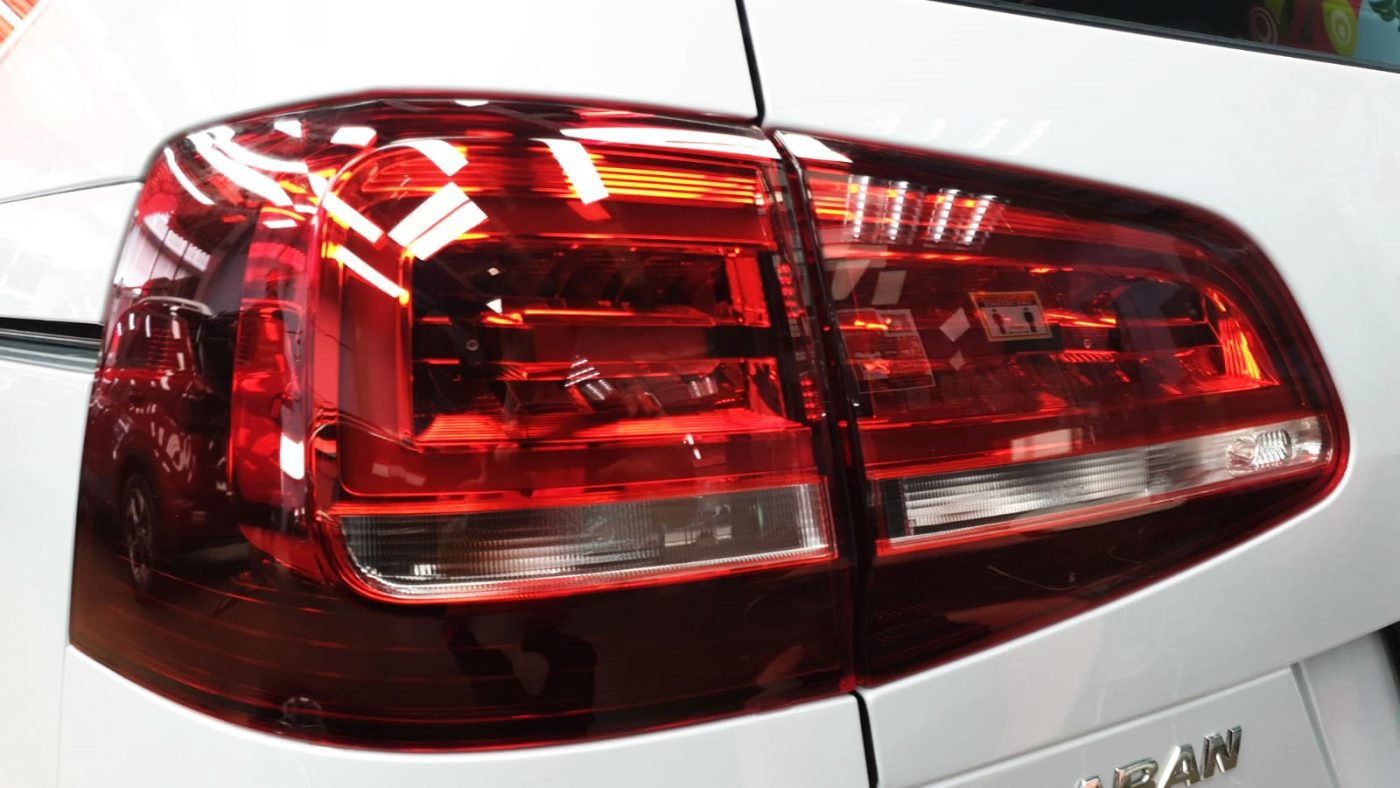 The coated bonnet of the Volkswagen Sharan under workshop lighting.