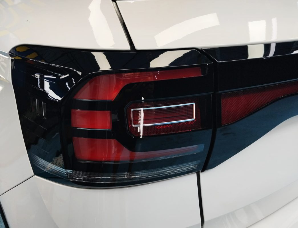 The coated bonnet of the Volkswagen T-Cross under workshop lighting.