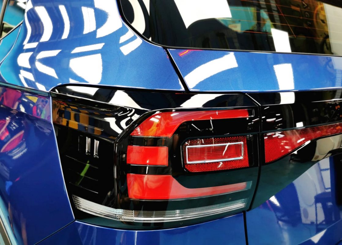The coated bonnet of the Volkswagen T-Cross R-Line under workshop lighting.