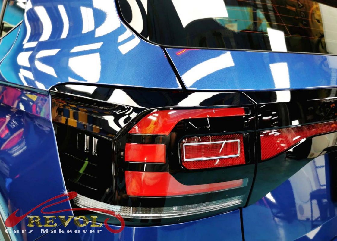 The coated bonnet of the Volkswagen T-Cross under workshop lighting.