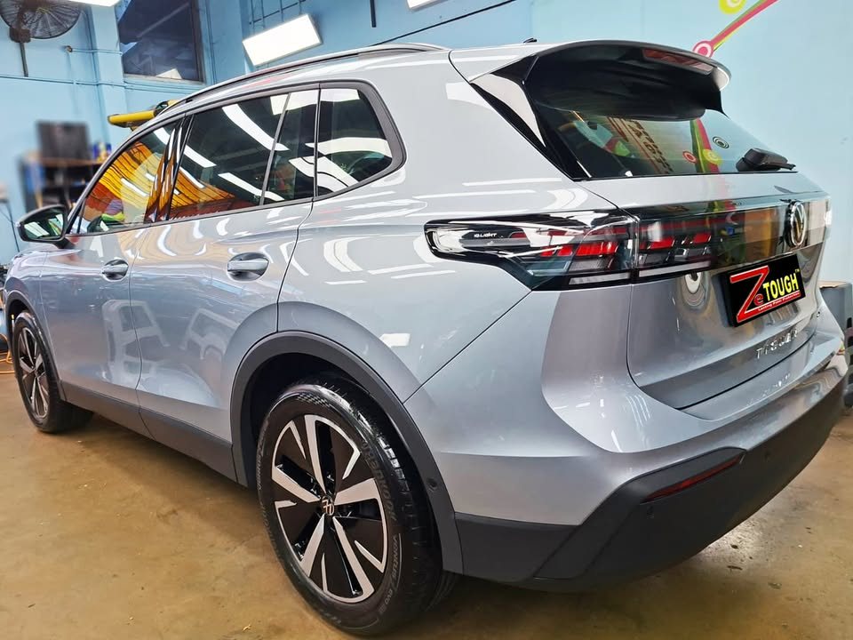 Silver grey Volkswagen Tiguan, rear three-quarter view, in the workshop.