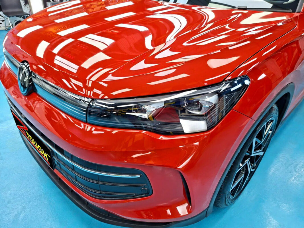 The Volkswagen Tiguan's coated paintwork under workshop lighting.