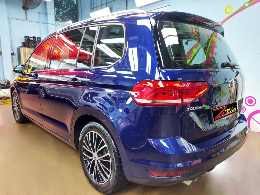 Rear quarter of the Volkswagen Touran, glossy and protected.