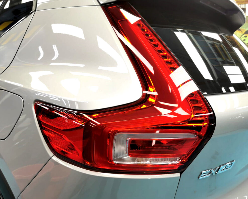 The coated bonnet of the Volvo EX40 under workshop lighting.
