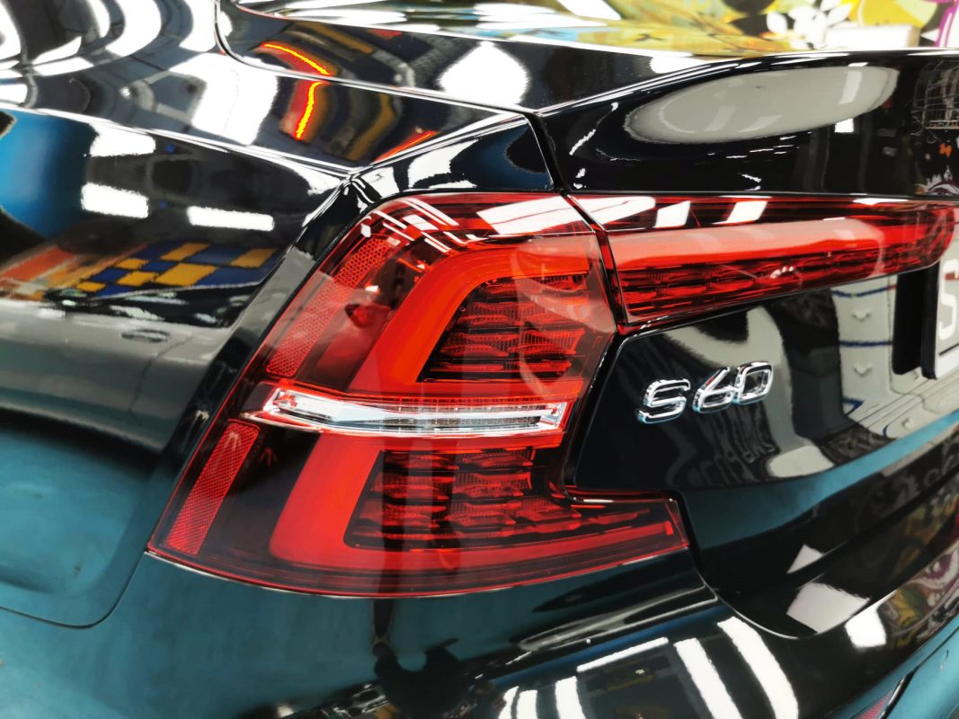 The coated bonnet of the Volvo S60 under workshop lighting.