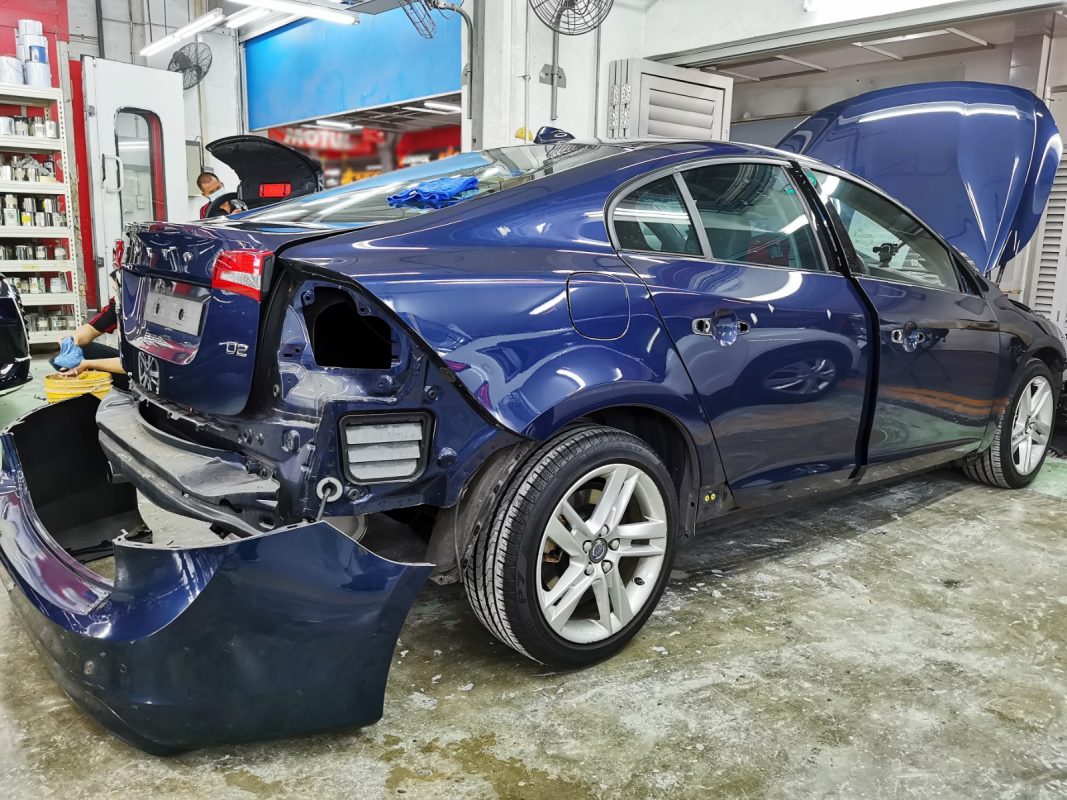 The Volvo S60 at an early stage of the job, with parts being dismantled.