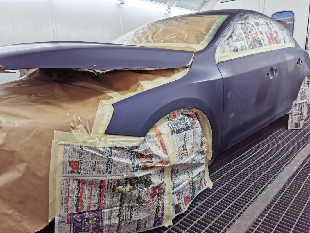 Non-painted surfaces being masked off on the S60 before spraying.