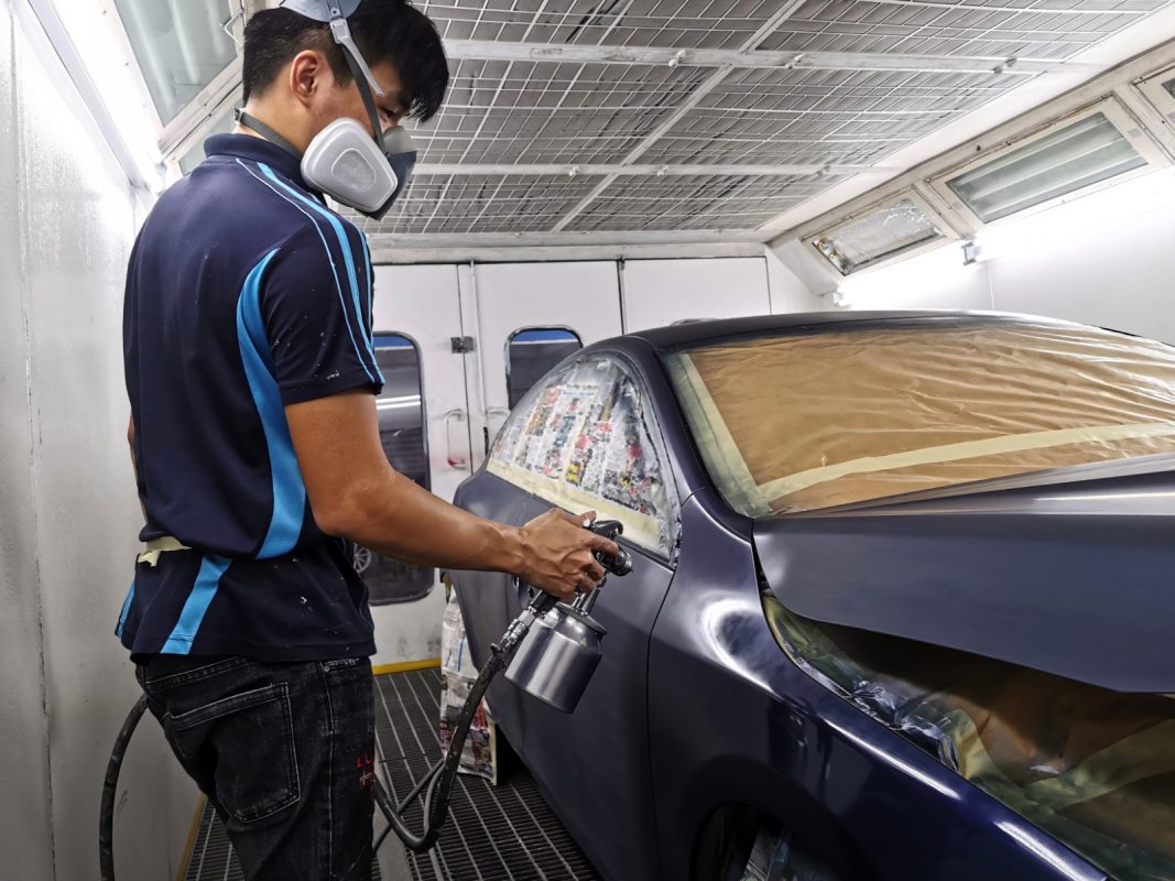 Touching up the S60's surfaces after spraying.