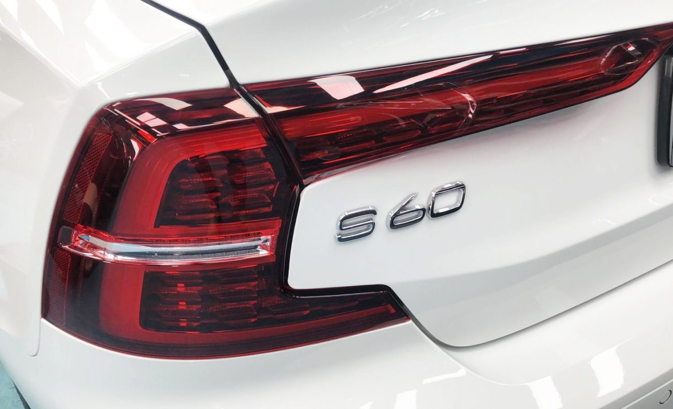 The coated bonnet of the Volvo S60 under workshop lighting.