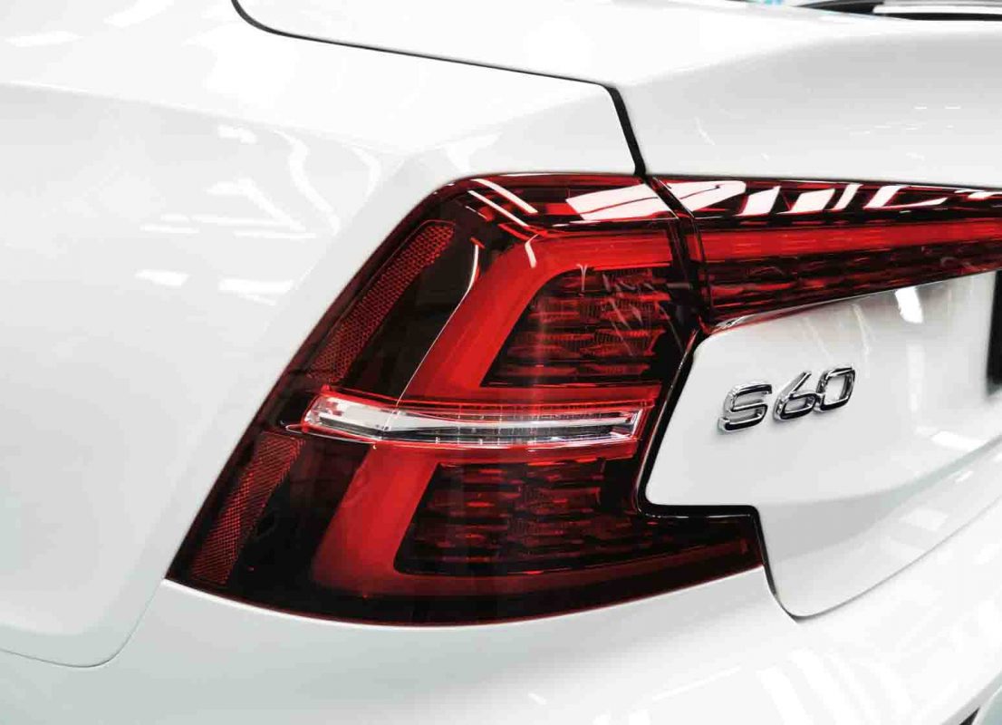 The coated bonnet of the Volvo S60 under workshop lighting.