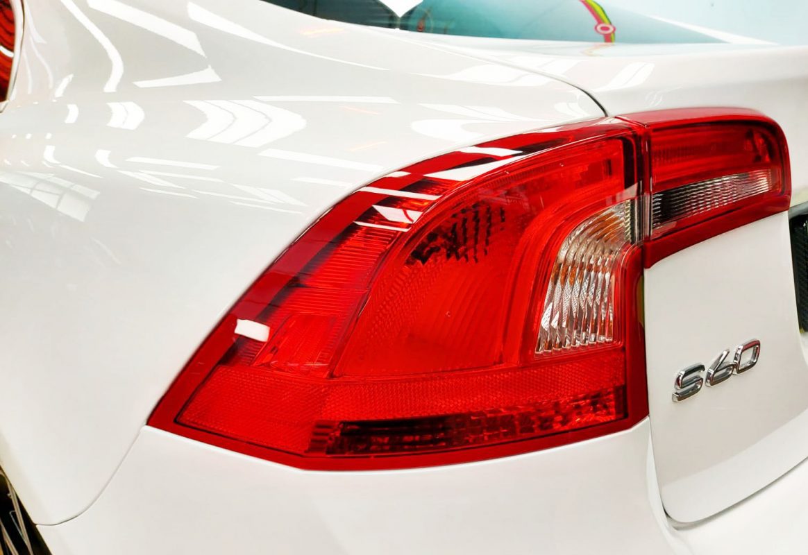 The coated bonnet of the Volvo S60 under workshop lighting.