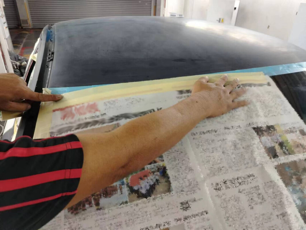 Wet-sanding continues on the Volvo S60R, smoothing the entire car before masking.