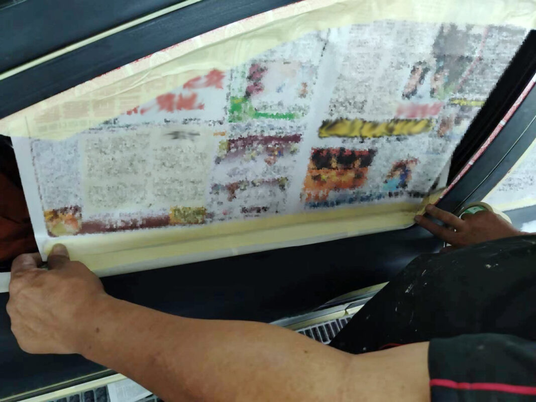 Masking paper applied to the Volvo S60R to protect non-painted surfaces.