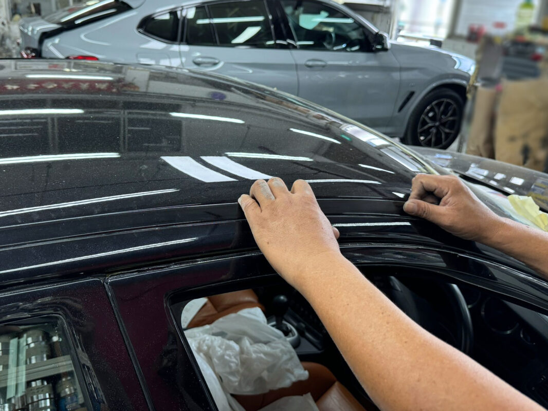 Wet-sanding the new coat on the Volvo S60R to remove any imperfections.