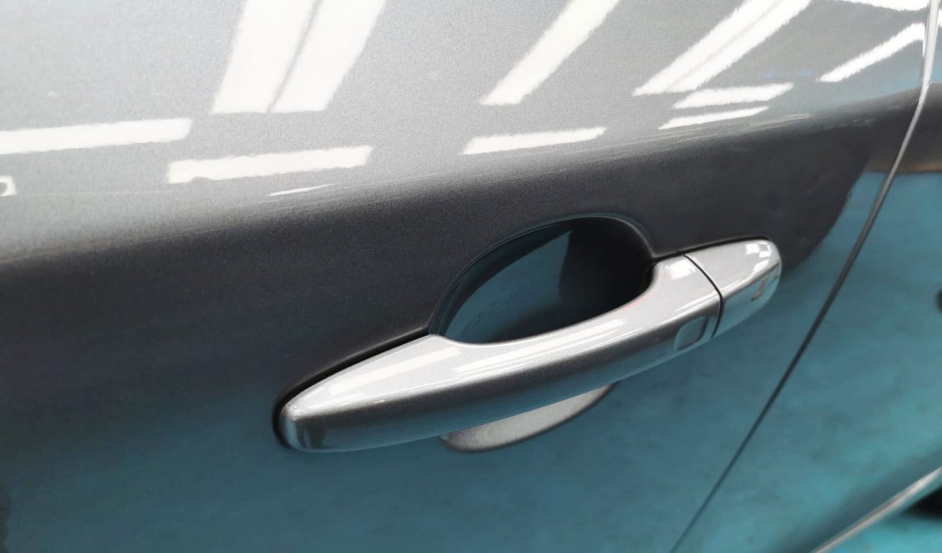 The coated bonnet of the Volvo S60 under workshop lighting.