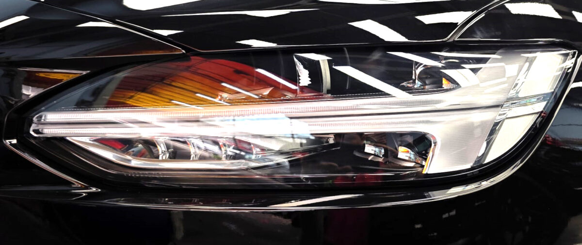 The S90's coated paintwork showing clean reflections.