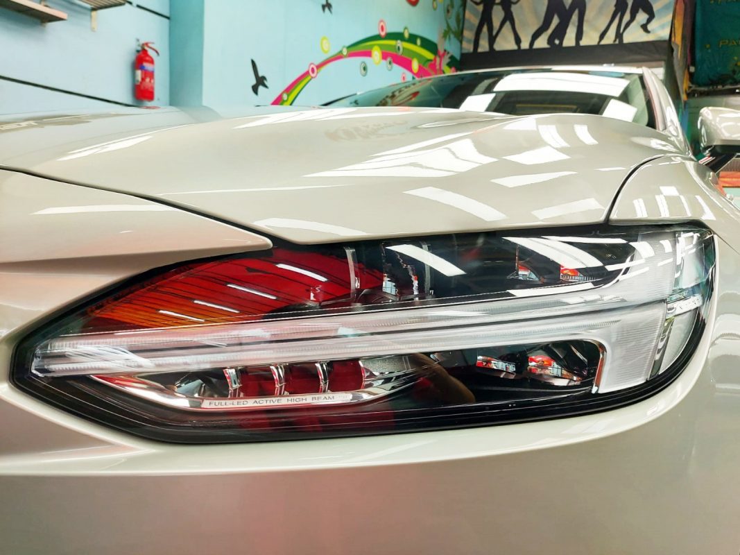 The S90's coated paintwork showing clean reflections.