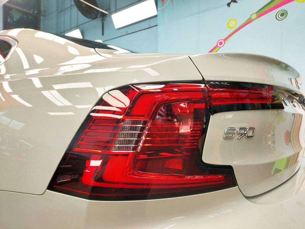 The coated bonnet of the Volvo S90 under workshop lighting.