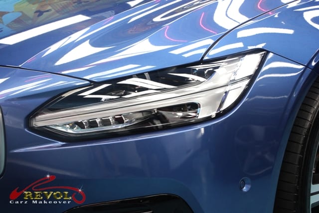 The V90's coated paintwork showing clean reflections.