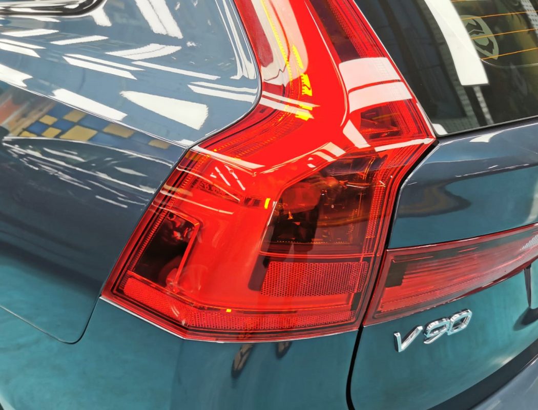 The coated bonnet of the Volvo V90 under workshop lighting.