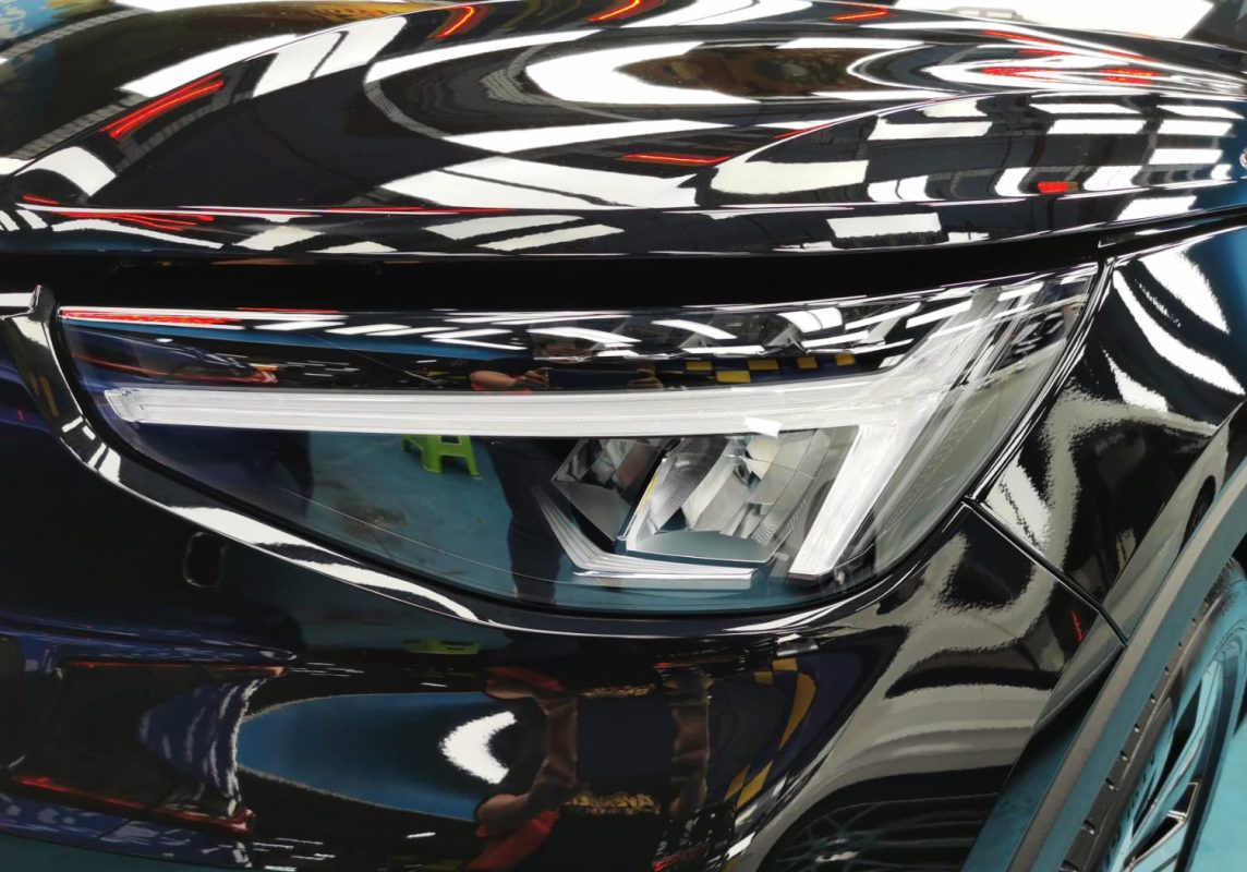 The XC40's coated paintwork showing clean reflections.