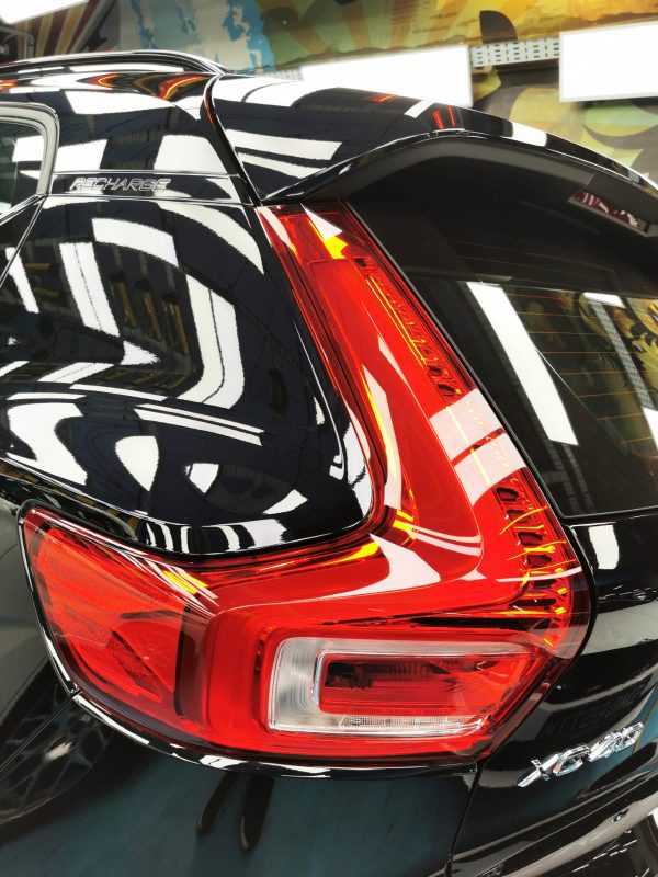 The coated bonnet of the Volvo XC40 under workshop lighting.