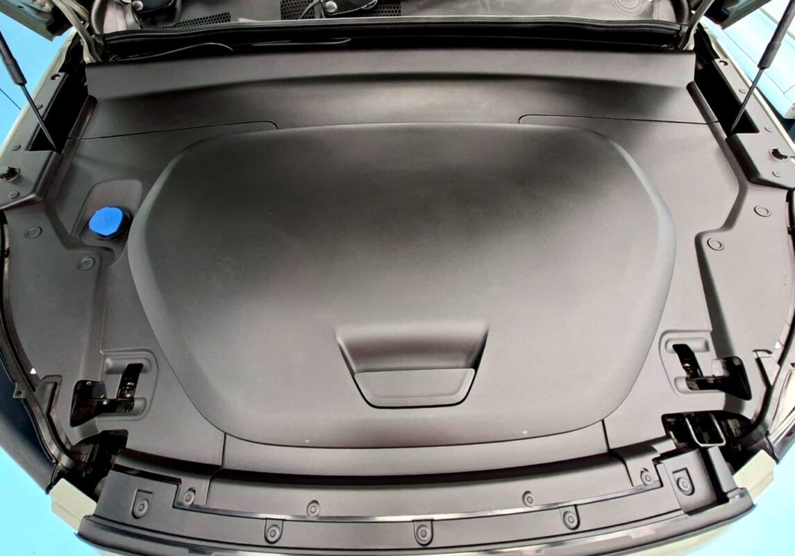 Reflections across the coated panels of the Volvo XC40.
