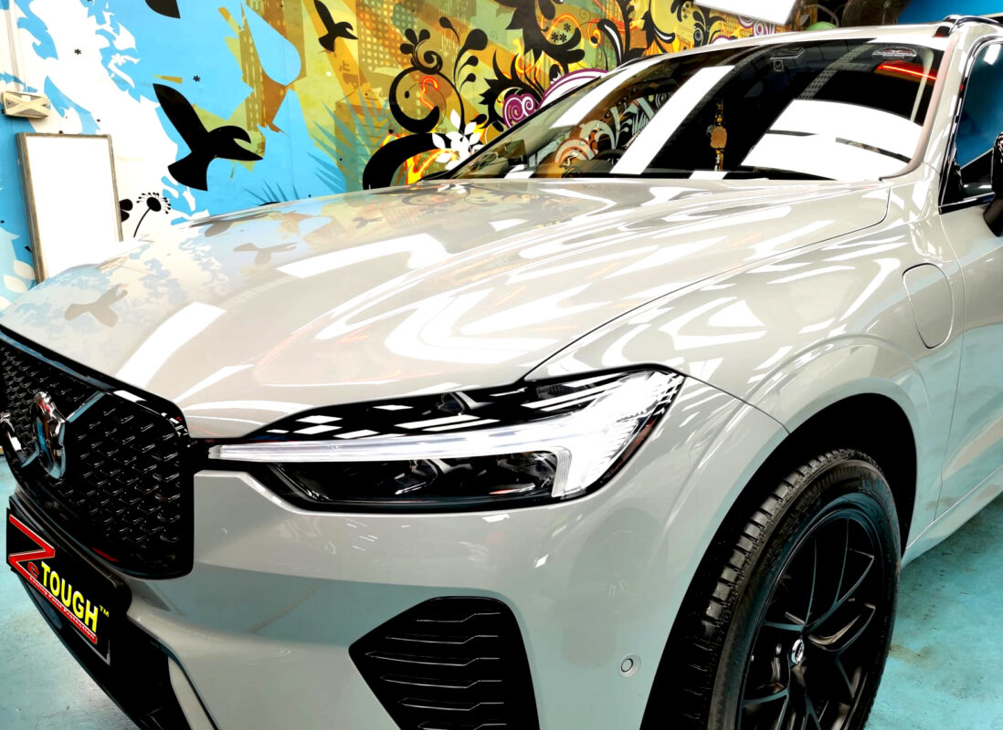 The Volvo XC60's coated paintwork under workshop lighting.
